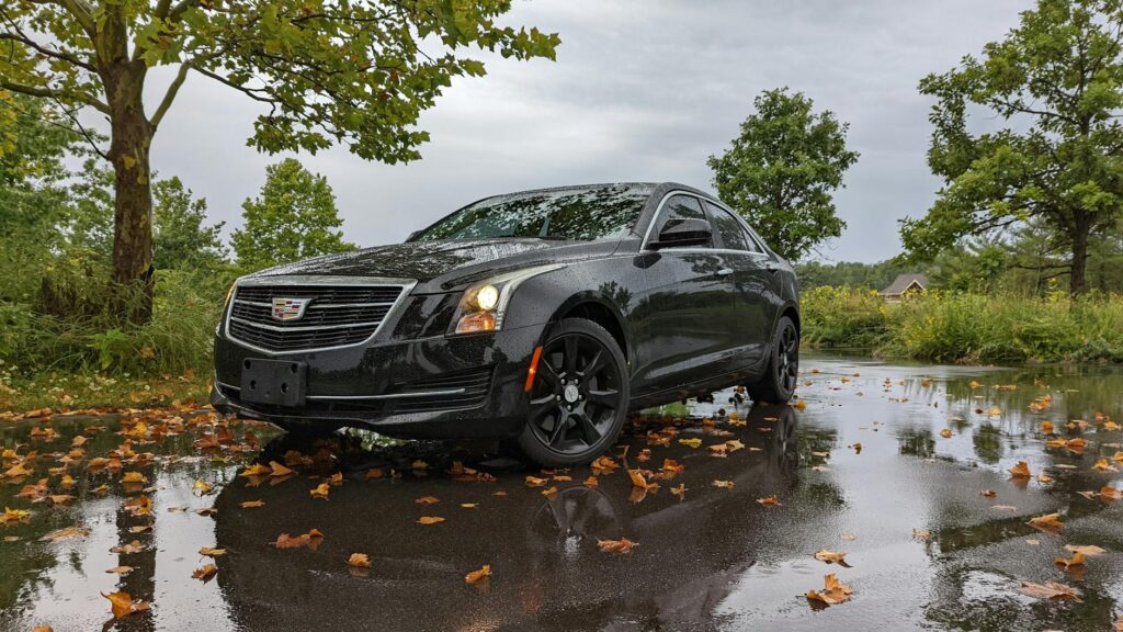 a black cadillac car parked on the street