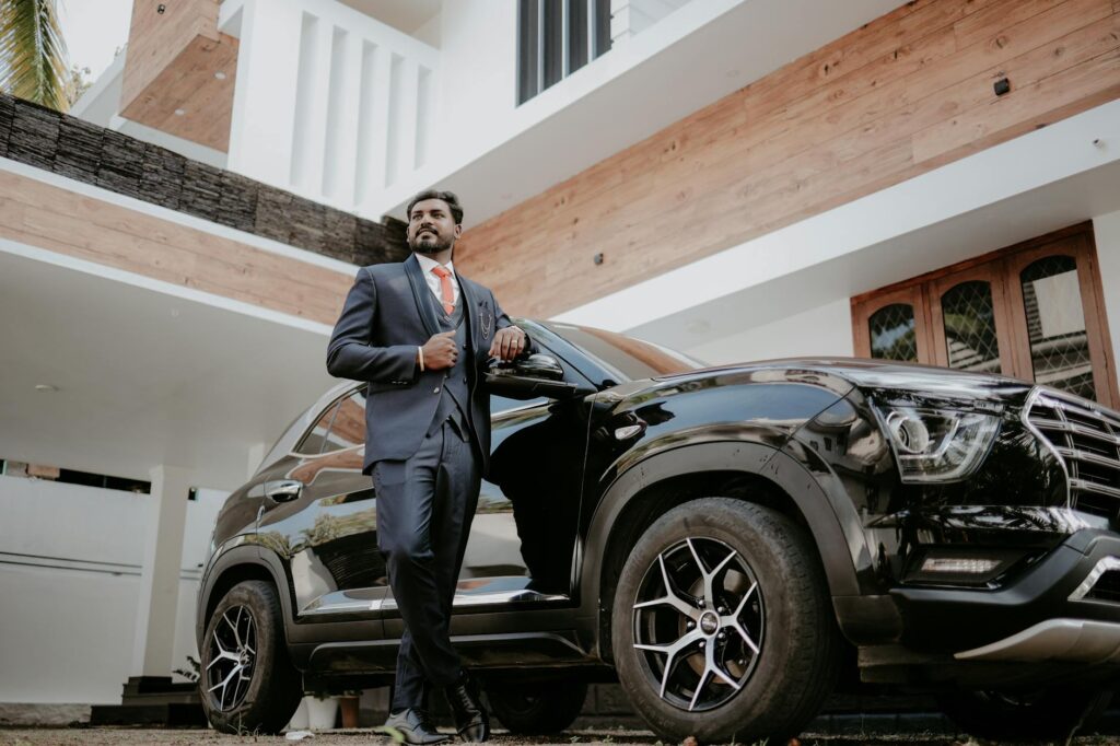 indian groom posing elegantly with luxury car