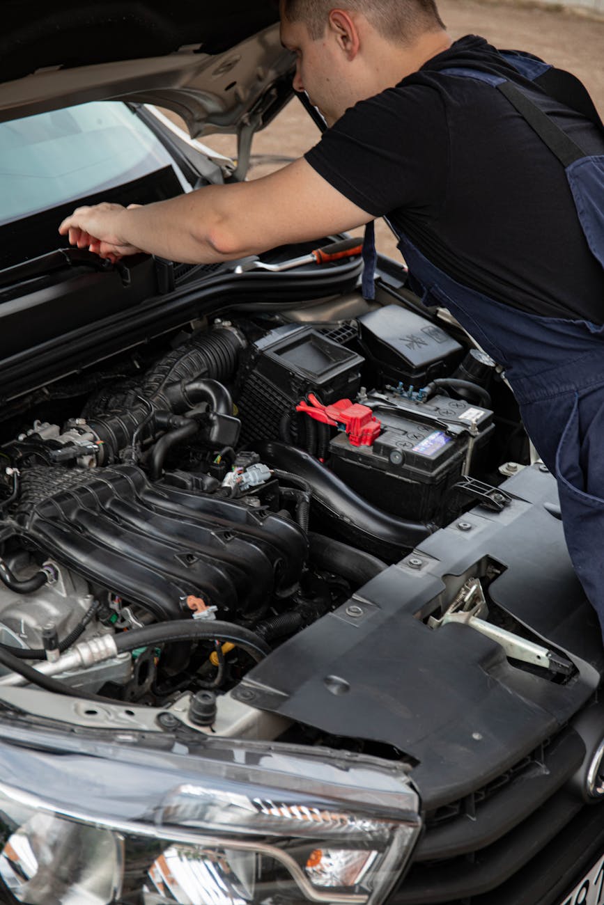 man repairing a car